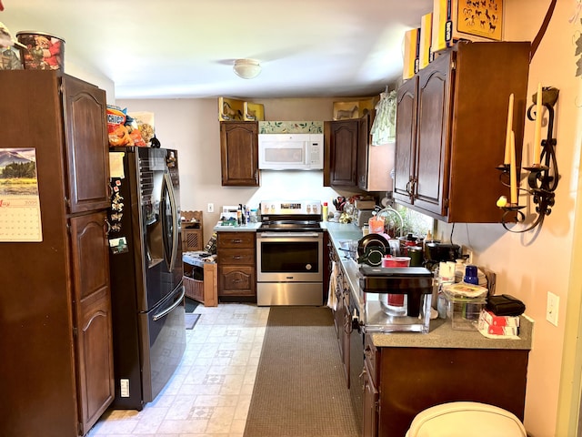 3 Rush Blvd, Millinocket, ME 04462 - kitchen featuring electric stove, white microwave, black fridge, light flooring, and light countertops