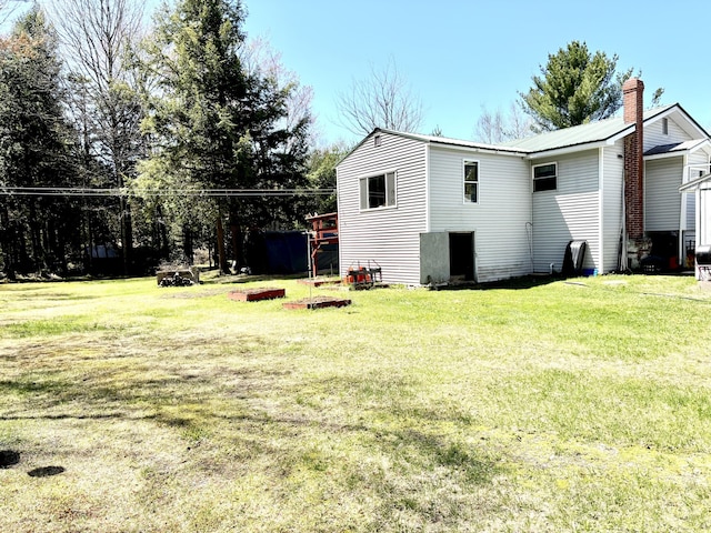 3 Rush Blvd, Millinocket, ME 04462 - back of house featuring a yard and a chimney