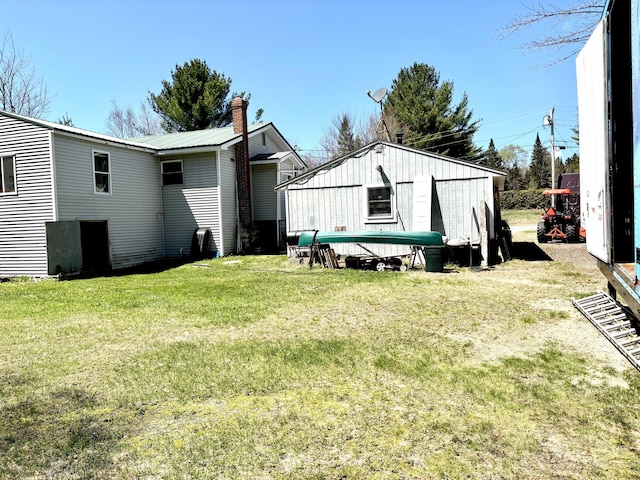 3 Rush Blvd, Millinocket, ME 04462 - rear view of house featuring a yard and a chimney