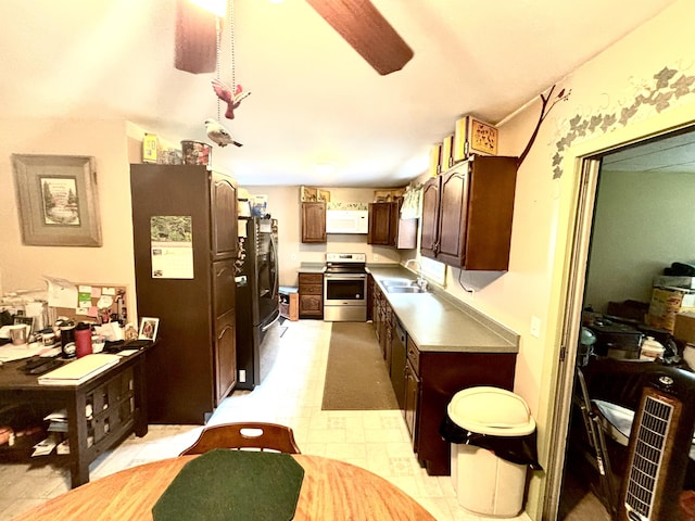3 Rush Blvd, Millinocket, ME 04462 - kitchen featuring electric stove, white microwave, freestanding refrigerator, dark brown cabinetry, and light countertops