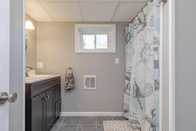 full bath featuring heating unit, vanity, baseboards, tile patterned flooring, and curtained shower