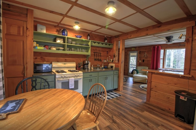 285 Quimby Pond Rd, Rangeley, ME 04970 - kitchen featuring white gas range, black microwave, green cabinetry, dark wood-type flooring, and wooden walls