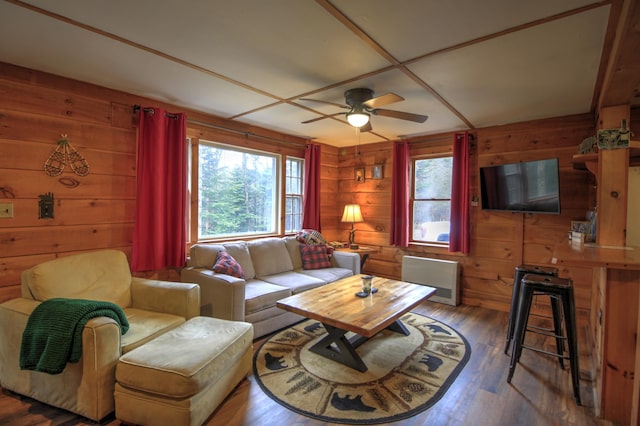 285 Quimby Pond Rd, Rangeley, ME 04970 - living room featuring wood walls, a ceiling fan, radiator heating unit, and wood finished floors