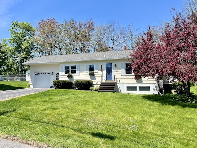 single story home featuring a garage, driveway, a front yard, and a chimney