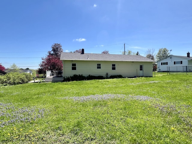 back of property featuring a lawn