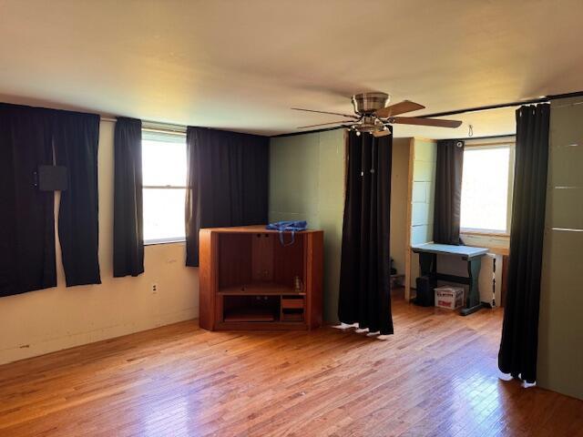 empty room featuring wood finished floors and a ceiling fan