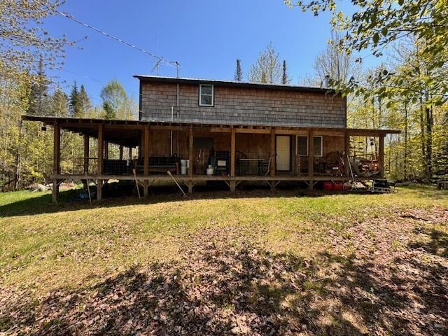 back of property featuring a yard