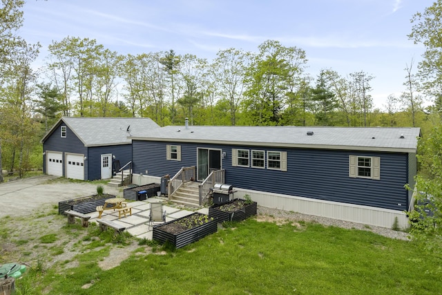 70 Lions Ridge Dr, Alna, ME 04535 - rear view of house with a garage, a yard, and view of scattered trees