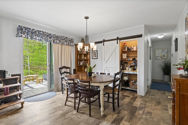 70 Lions Ridge Dr, Alna, ME 04535 - dining space with a barn door, wood finished floors, and a chandelier