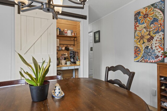 70 Lions Ridge Dr, Alna, ME 04535 - dining space featuring a barn door and ornamental molding