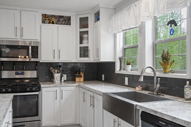 70 Lions Ridge Dr, Alna, ME 04535 - kitchen with stainless steel appliances, white cabinets, tasteful backsplash, and a sink