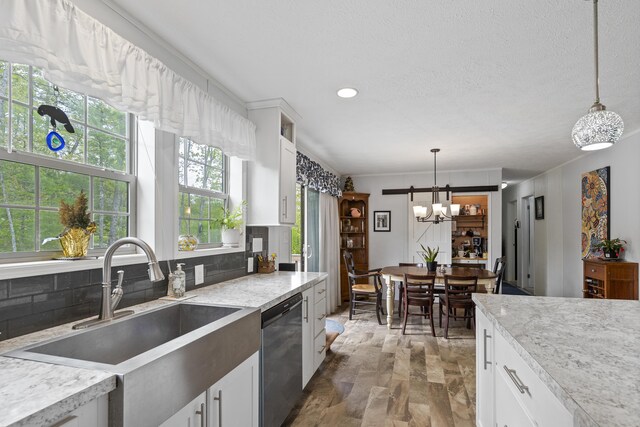 70 Lions Ridge Dr, Alna, ME 04535 - kitchen with dishwasher, a sink, backsplash, white cabinets, and a chandelier