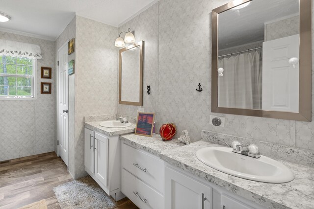70 Lions Ridge Dr, Alna, ME 04535 - full bathroom featuring two vanities, wood finished floors, and crown molding