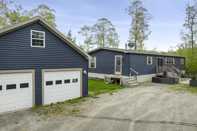 70 Lions Ridge Dr, Alna, ME 04535 - view of front of house with asphalt driveway and a garage