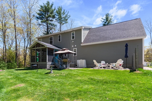 989 Littlefield Rd, Wells, ME 04090 - rear view of house featuring a sunroom, roof with shingles, and a lawn