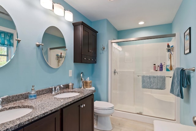 989 Littlefield Rd, Wells, ME 04090 - full bathroom with a stall shower, toilet, double vanity, wood finished floors, and recessed lighting