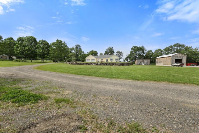 585 Charleston Rd, Charleston, ME 04422 - view of front of property with a front yard, a garage, and an outbuilding