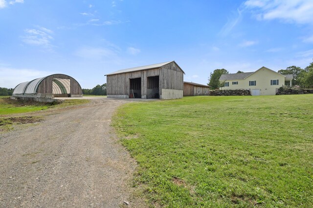 585 Charleston Rd, Charleston, ME 04422 - view of pole building with dirt driveway and a lawn