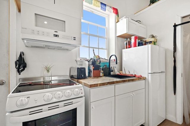 585 Charleston Rd, Charleston, ME 04422 - kitchen with white appliances, butcher block countertops, and white cabinets