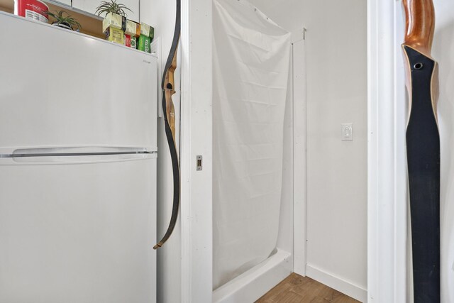 585 Charleston Rd, Charleston, ME 04422 - bathroom with wood finished floors and a shower with curtain