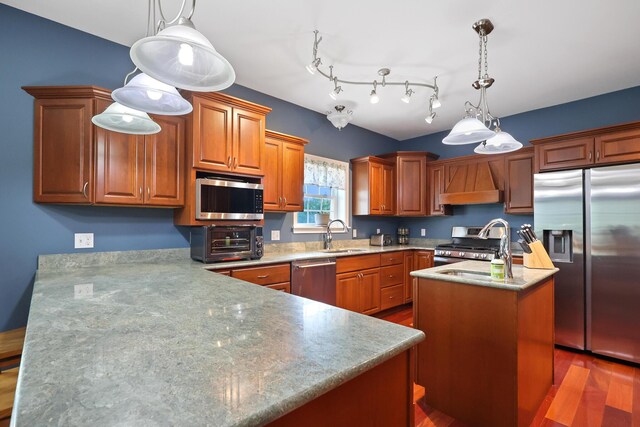 585 Charleston Rd, Charleston, ME 04422 - kitchen featuring appliances with stainless steel finishes, custom range hood, a center island with sink, dark wood-style flooring, and brown cabinets