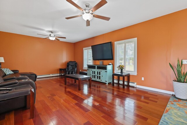 585 Charleston Rd, Charleston, ME 04422 - living room with a baseboard heating unit, a ceiling fan, wood finished floors, and a baseboard radiator