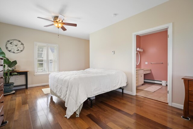 585 Charleston Rd, Charleston, ME 04422 - bedroom with a baseboard radiator, wood finished floors, connected bathroom, and ceiling fan