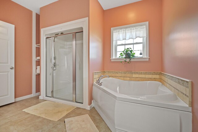 585 Charleston Rd, Charleston, ME 04422 - bathroom featuring a shower stall, a bath, and tile patterned flooring