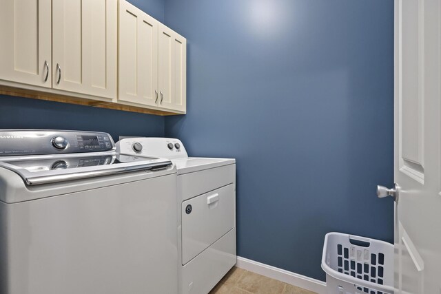 585 Charleston Rd, Charleston, ME 04422 - laundry area featuring separate washer and dryer, cabinet space, and light tile patterned floors