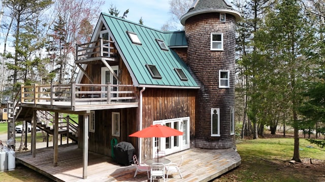 832 Main Rd, Islesboro, ME 04848 - back of house with a standing seam roof, a wooden deck, metal roof, and a lawn