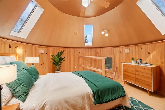832 Main Rd, Islesboro, ME 04848 - bedroom with a skylight, wooden walls, and light wood-type flooring