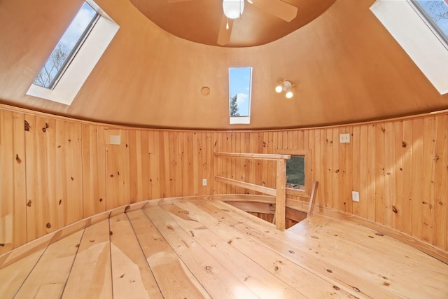 832 Main Rd, Islesboro, ME 04848 - additional living space with a skylight, wood walls, a sauna / steam room, hardwood / wood-style floors, and a ceiling fan