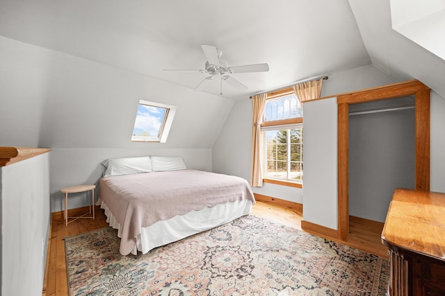 832 Main Rd, Islesboro, ME 04848 - bedroom with lofted ceiling, wood finished floors, a skylight, a ceiling fan, and baseboards