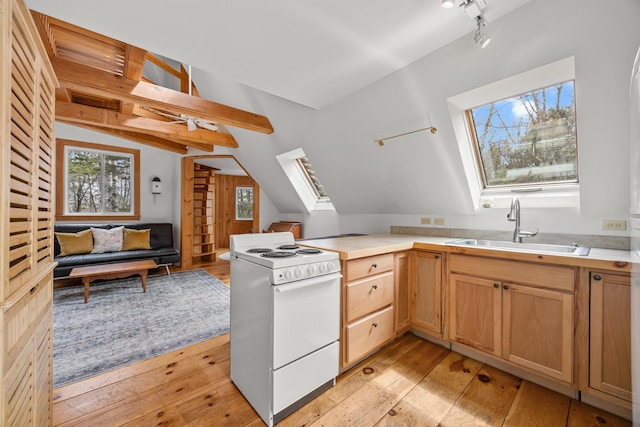 832 Main Rd, Islesboro, ME 04848 - kitchen featuring white electric range oven, a sink, a skylight, healthy amount of natural light, and vaulted ceiling