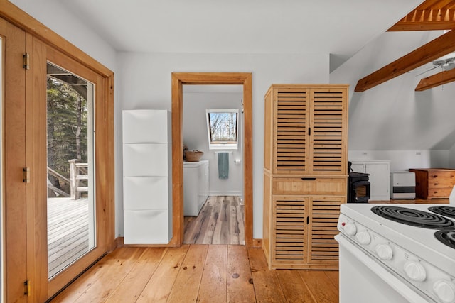 832 Main Rd, Islesboro, ME 04848 - kitchen with white range with electric stovetop, plenty of natural light, light wood-style flooring, and independent washer and dryer
