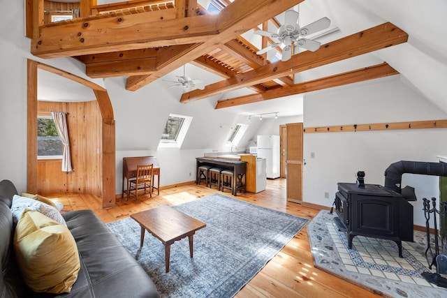 832 Main Rd, Islesboro, ME 04848 - living room featuring a ceiling fan, light wood-type flooring, a wood stove, and baseboards