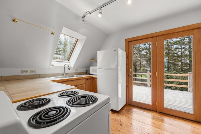 832 Main Rd, Islesboro, ME 04848 - kitchen featuring white appliances, a sink, plenty of natural light, lofted ceiling, and light countertops