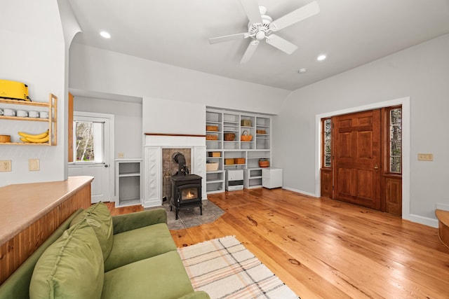 832 Main Rd, Islesboro, ME 04848 - living room with a wood stove, light wood-style flooring, a ceiling fan, baseboards, and recessed lighting
