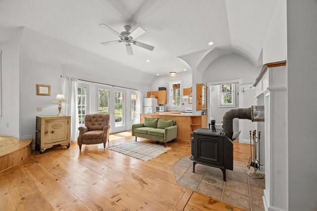 832 Main Rd, Islesboro, ME 04848 - living room featuring light wood-style floors, vaulted ceiling, ceiling fan, recessed lighting, and a wood stove