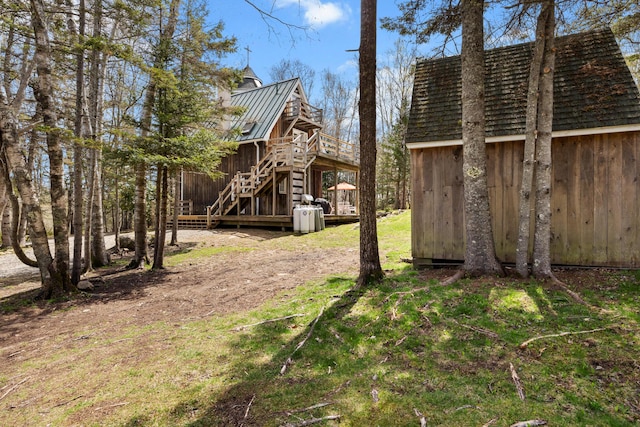 832 Main Rd, Islesboro, ME 04848 - view of yard with stairway, a wooden deck, and an outdoor structure