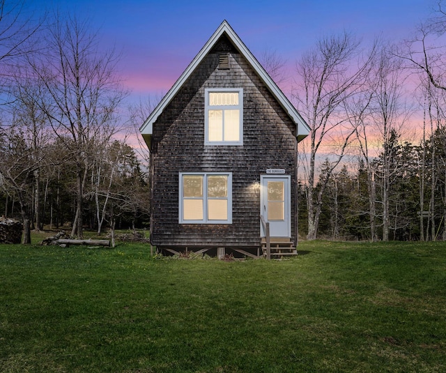 832 Main Rd, Islesboro, ME 04848 - back of house at dusk featuring entry steps and a yard