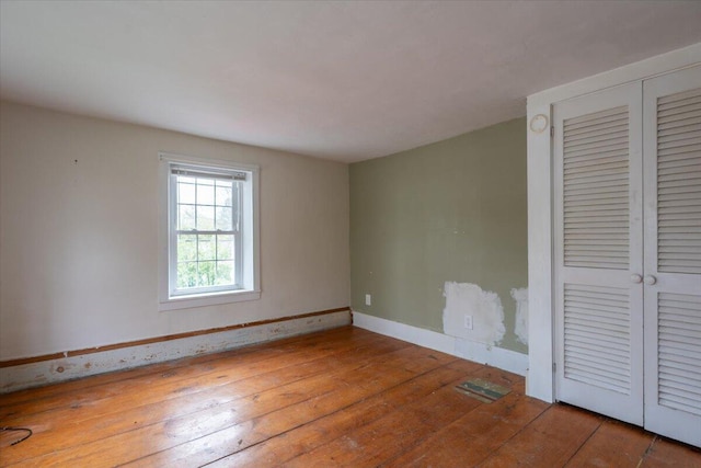41 Church St, Damariscotta, ME 04543 - unfurnished bedroom featuring baseboards, wood-type flooring, and a closet