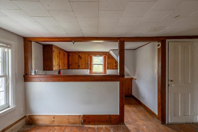 41 Church St, Damariscotta, ME 04543 - kitchen featuring brown cabinetry, baseboards, hardwood / wood-style floors, and a peninsula