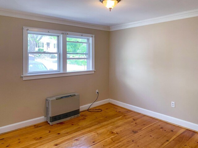 41 Church St, Damariscotta, ME 04543 - empty room with heating unit, ornamental molding, light wood-style flooring, and baseboards