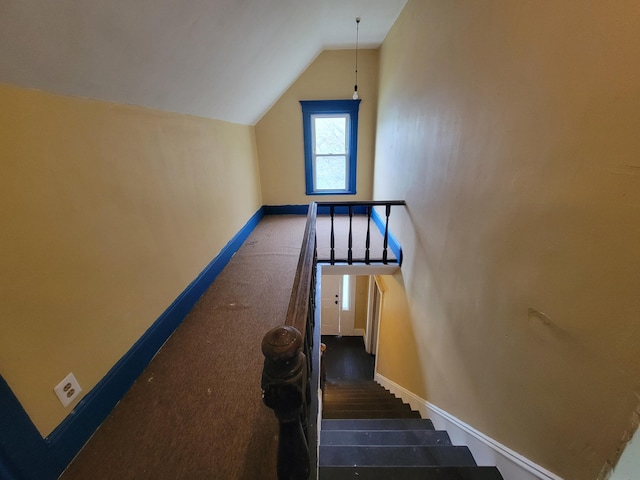 stairs with vaulted ceiling, baseboards, and carpet floors