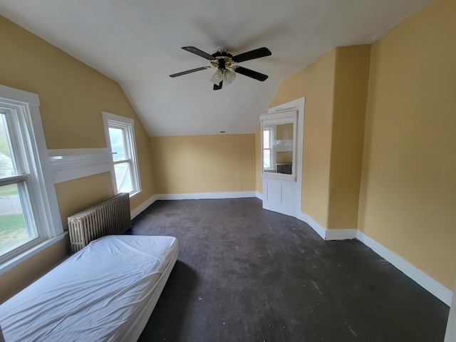 bedroom featuring radiator, lofted ceiling, baseboards, and a ceiling fan