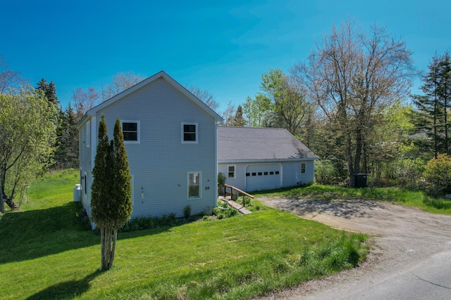 26 Flat Iron Rd, Tremont, ME 04653 - view of side of property with driveway, a yard, and an attached garage