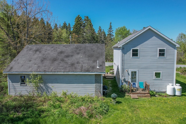 26 Flat Iron Rd, Tremont, ME 04653 - back of property with a yard and a wooden deck