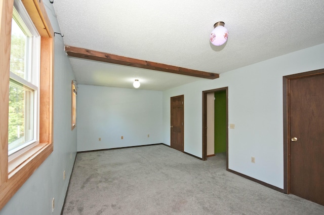 26 Flat Iron Rd, Tremont, ME 04653 - unfurnished room with carpet flooring, a textured ceiling, and beamed ceiling