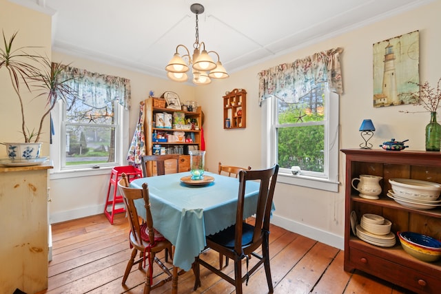 4 Otis St, Rockland, ME 04841 - dining area with baseboards, a chandelier, light wood-style flooring, and crown molding
